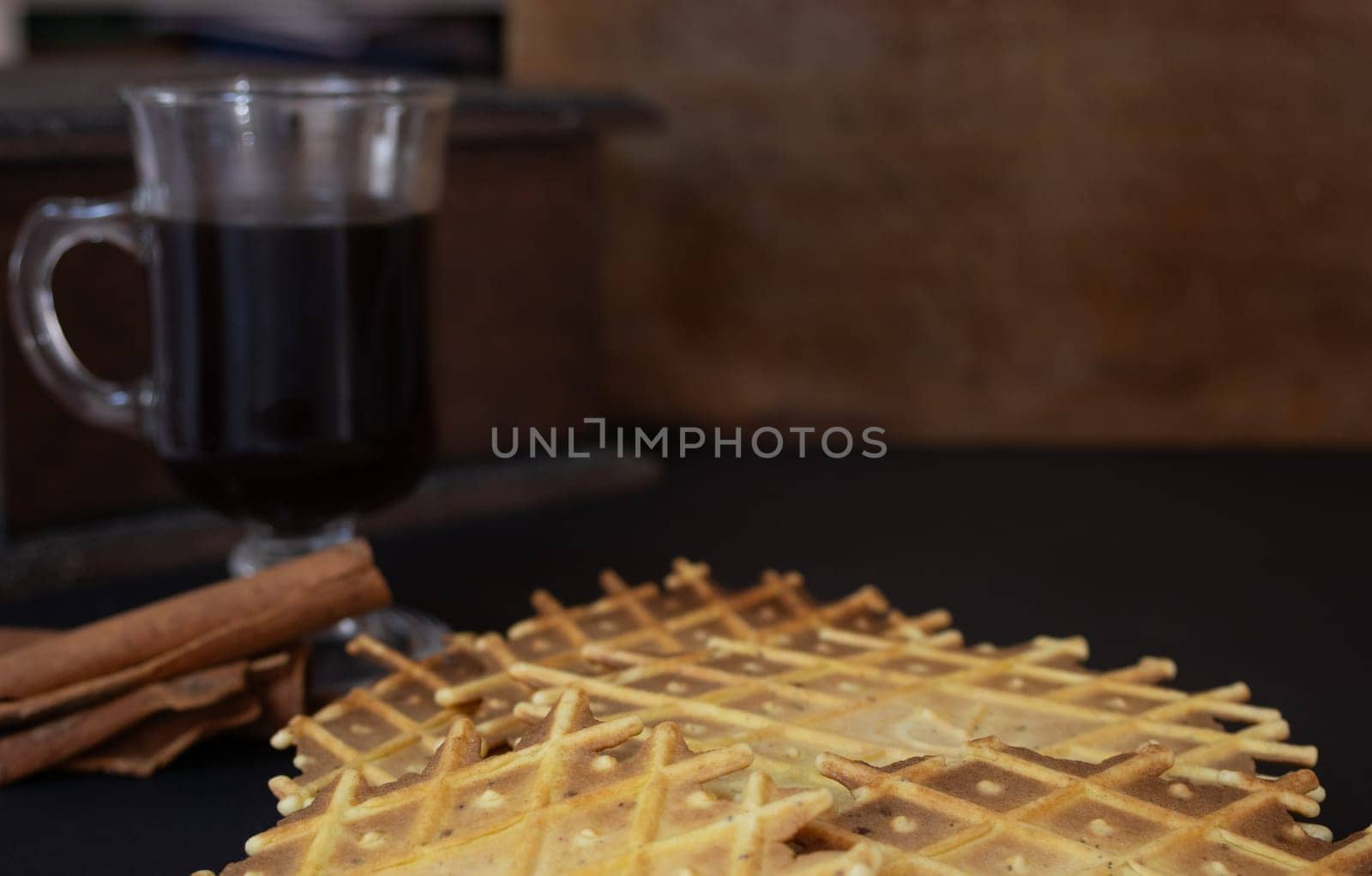 Very close-up photo of a cup of coffee with crunchy cinnamon biscuits. by VeroDibe