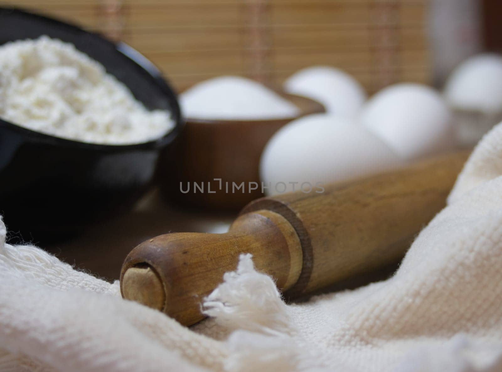 Close-up photo of a rolling pin and ingredients for gourmet biscuits. by VeroDibe