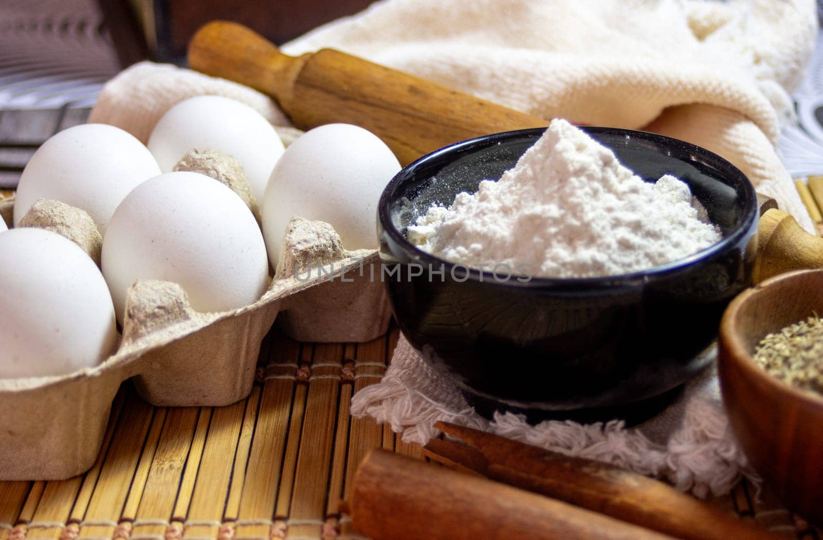 Eggs, flour and flavours for making biscuits. Side view photo by VeroDibe