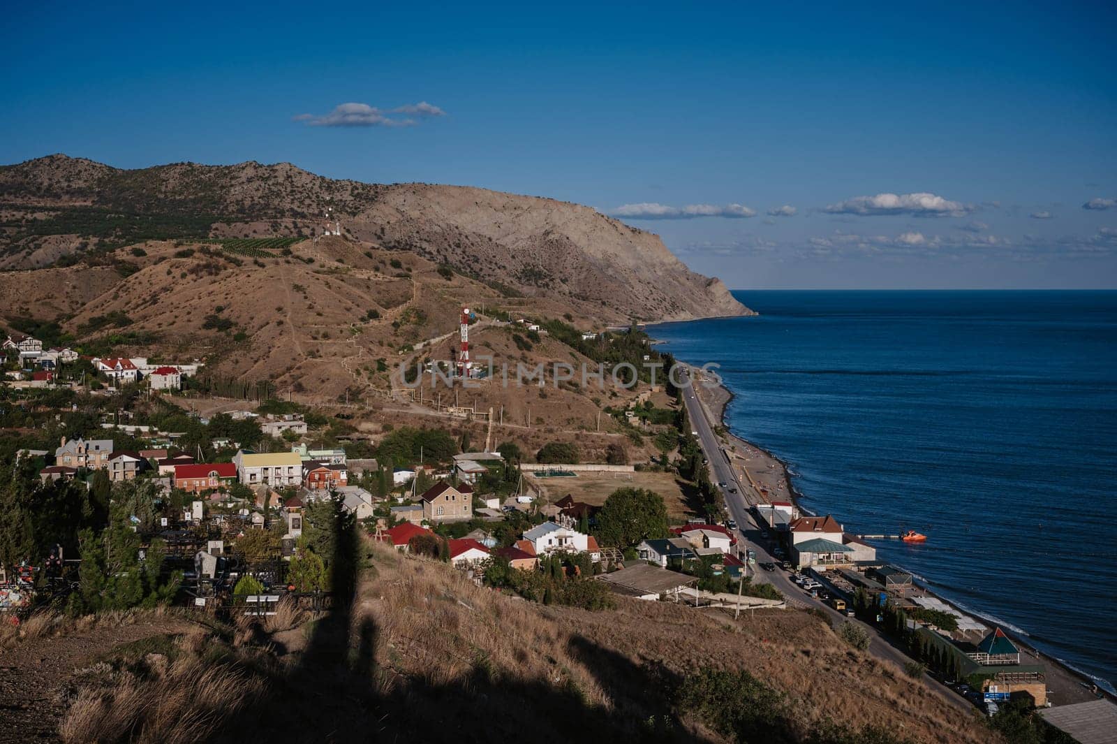 View of resort village of Morskoye on the Black Sea coast in Crimea in summer
