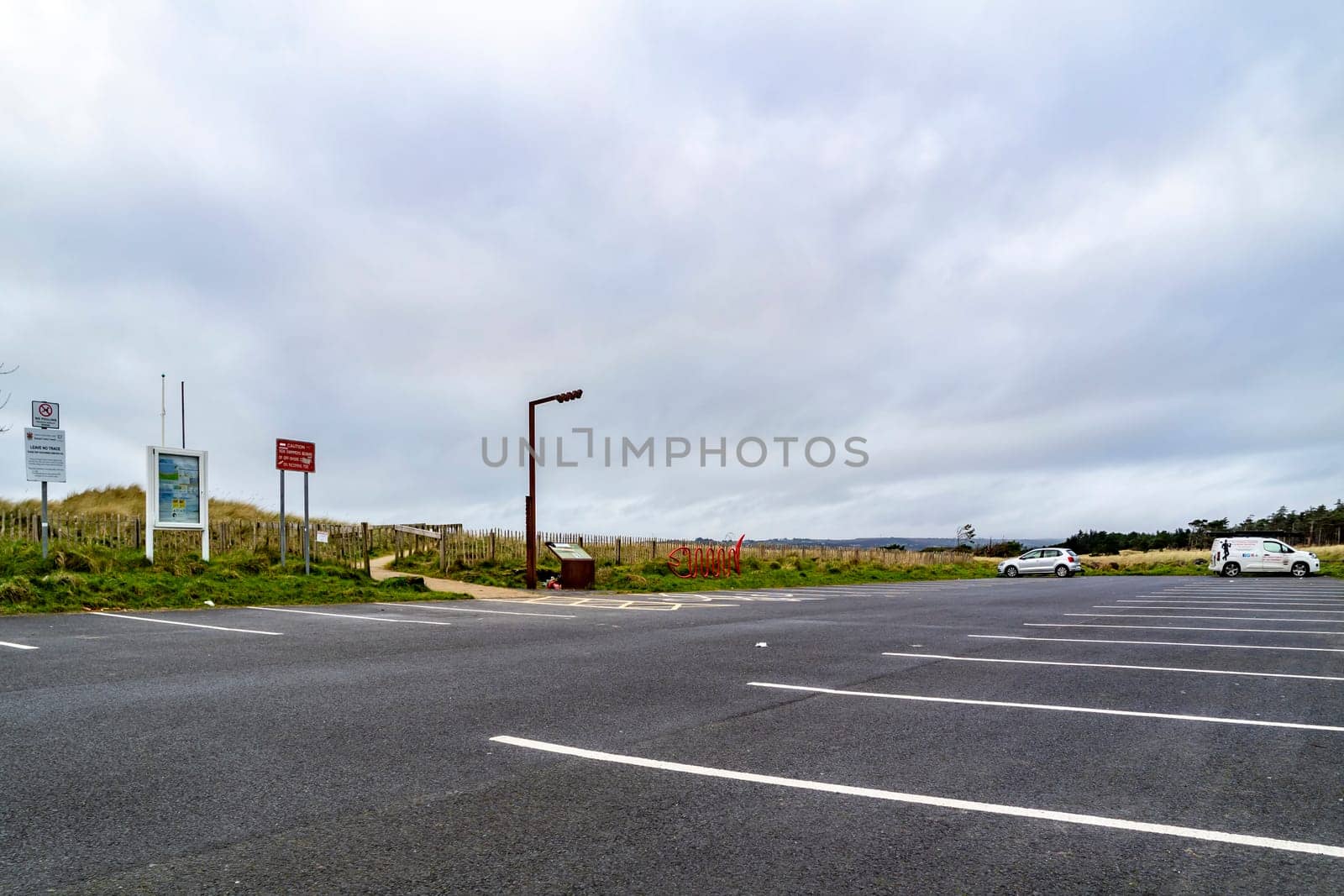 MURVAGH, COUNTY DONEGAL, IRELAND - JANUARY 21 2022 : The parking lot at the beach is almost empty.