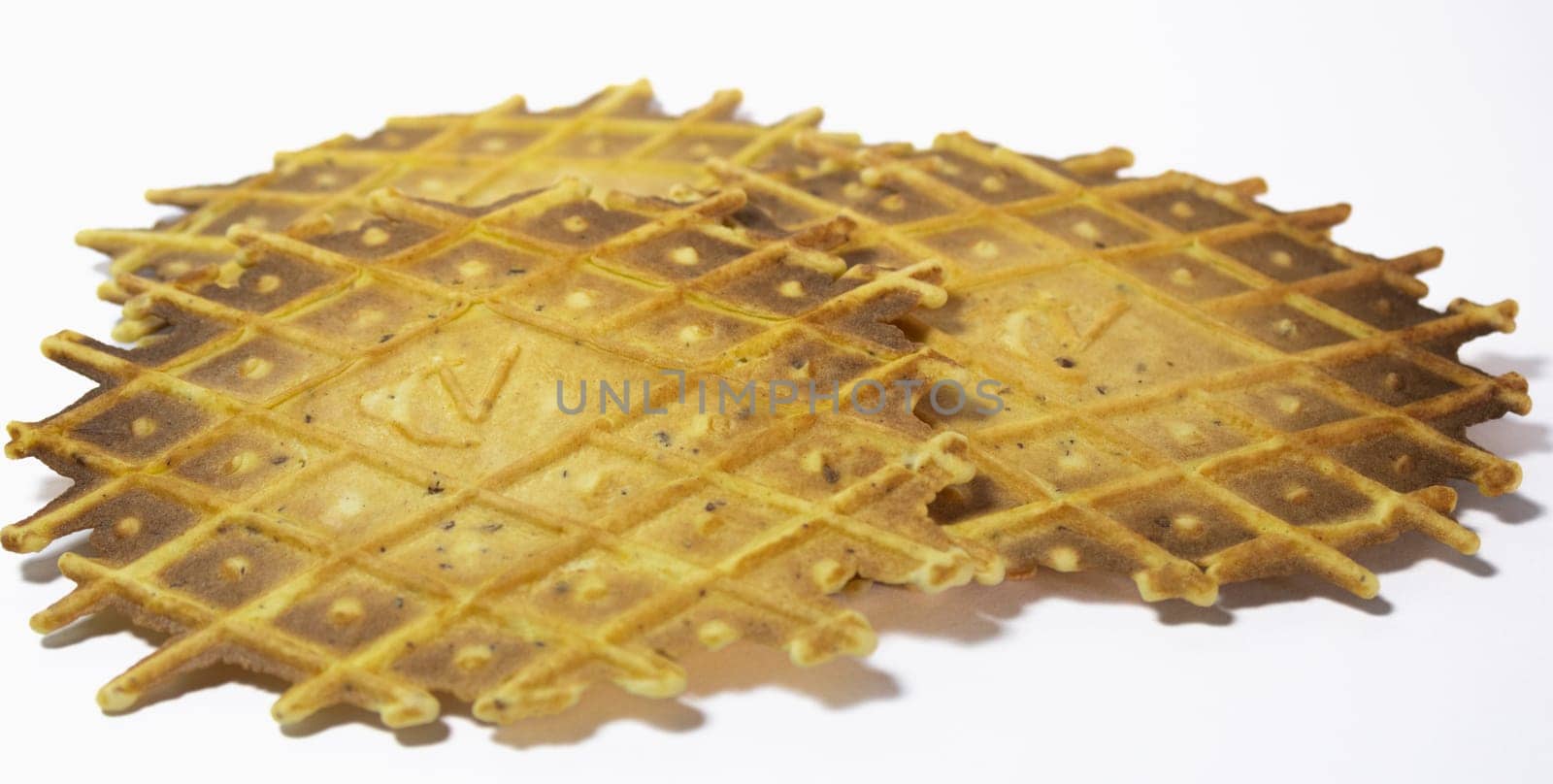 Pizzelles on white background. Side view. Isolated by VeroDibe