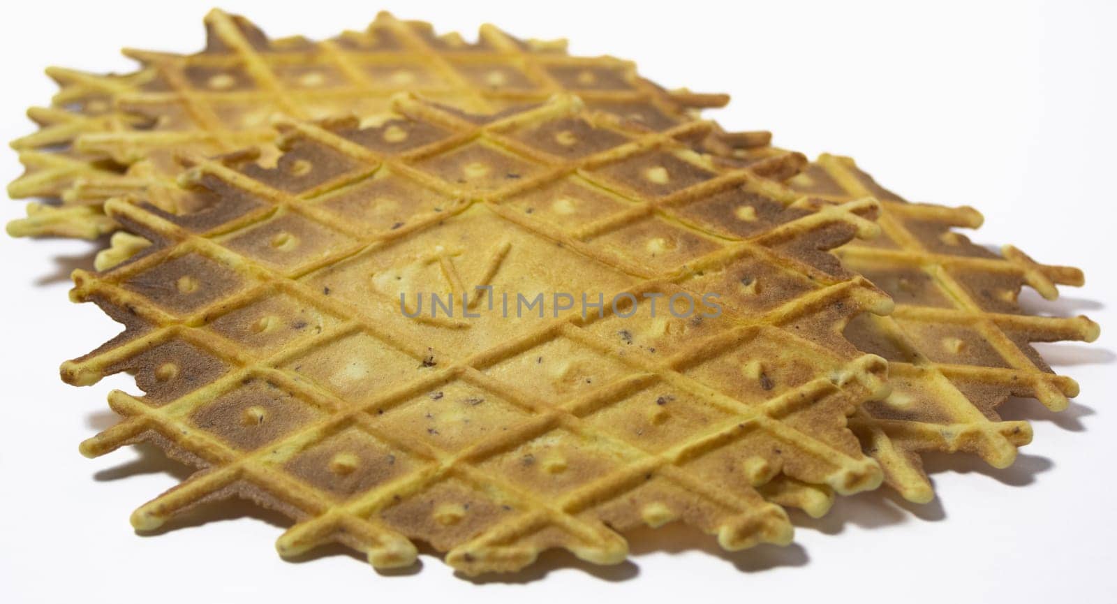 Group of pizzelles on white background. Spiced biscuits of Italian origin. by VeroDibe