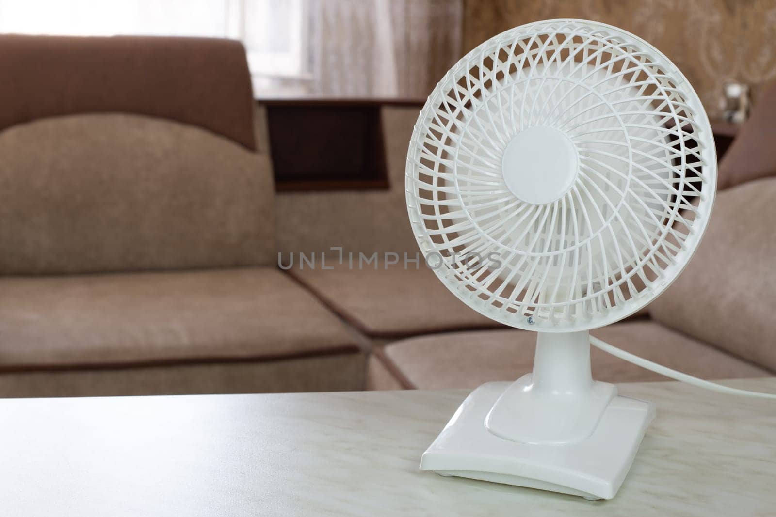 White fan with fast rotating blades for cool air flow in home room by timurmalazoniia