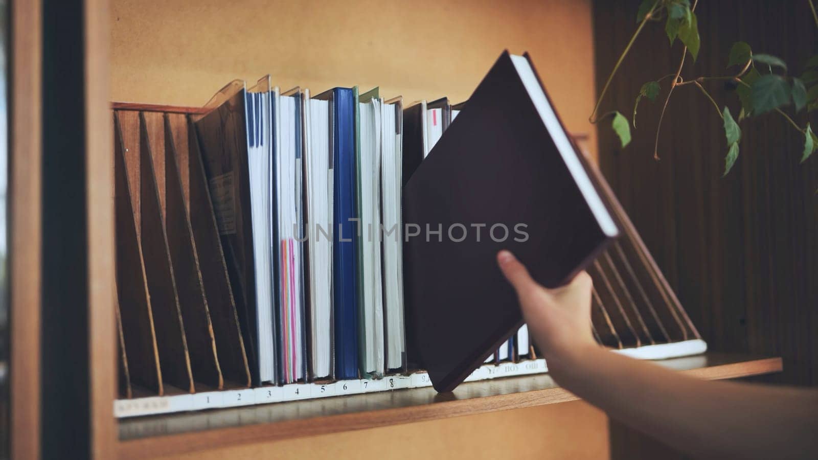 The teacher takes a school teacher's magazine from the shelf