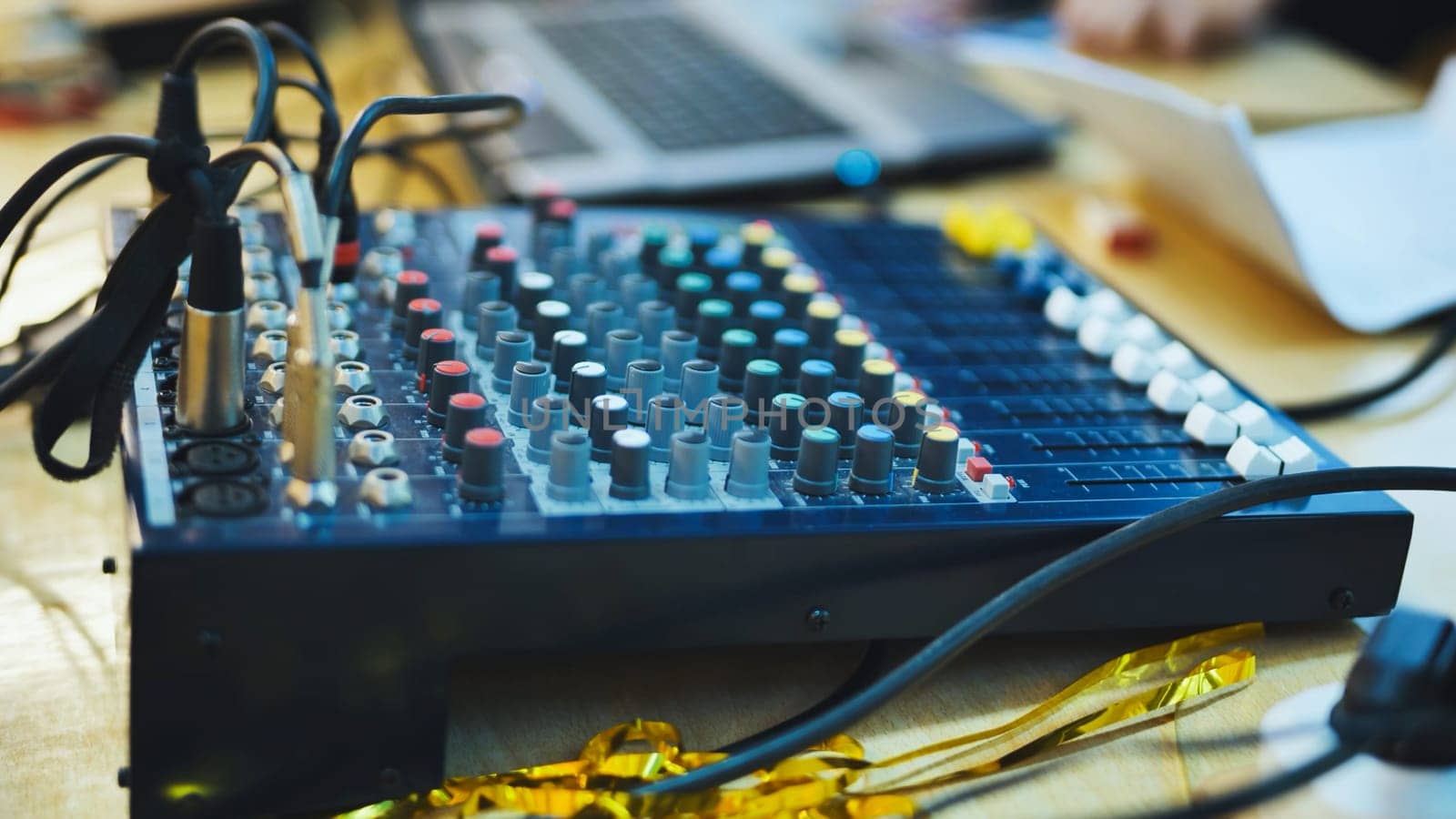 A skilled sound engineer uses a tablet to fine-tune the audio levels during a dynamic live concert performance.