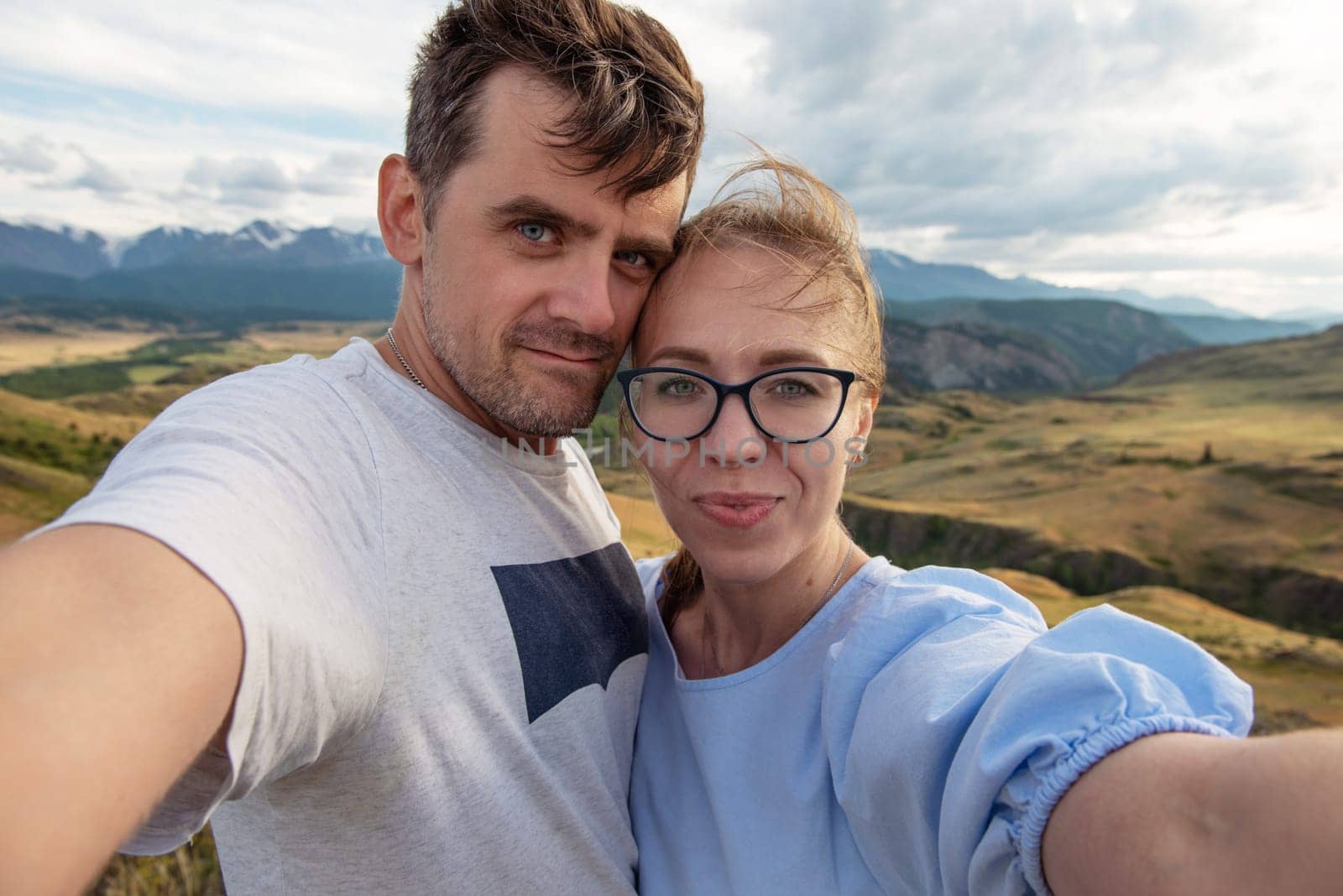 Selfie of couple family in Altai mountain. Happy man and woman. Travel concept