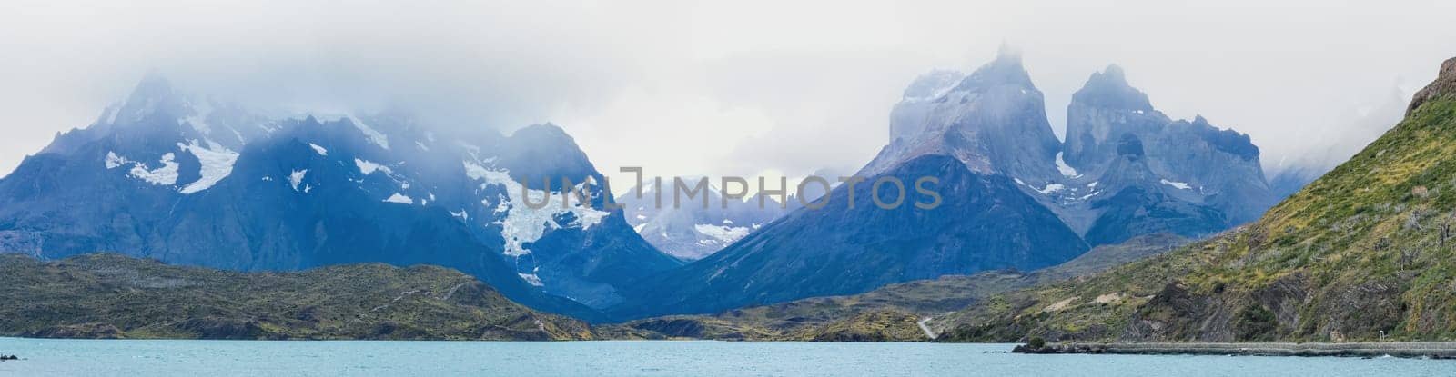 Majestic Mountain Range Towers Over Tranquil Lake by FerradalFCG