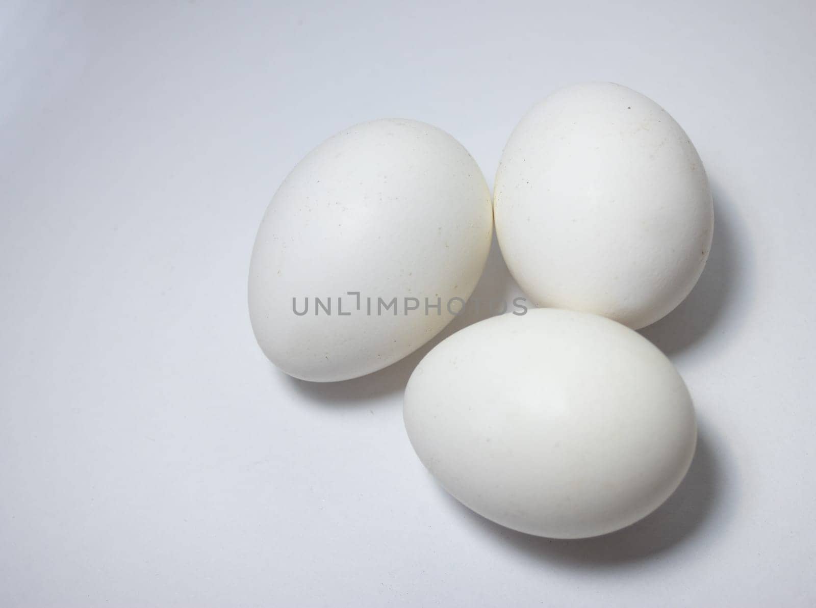 Top view, close up picture of a group of eggs , isolated ,on white background by VeroDibe