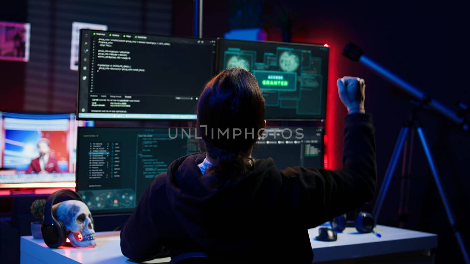 Happy hacker in secret hideout celebrating after managing to hide online activity after stealing data. Cheerful scammer feeling proud after successfully attacking victims using malware, camera B