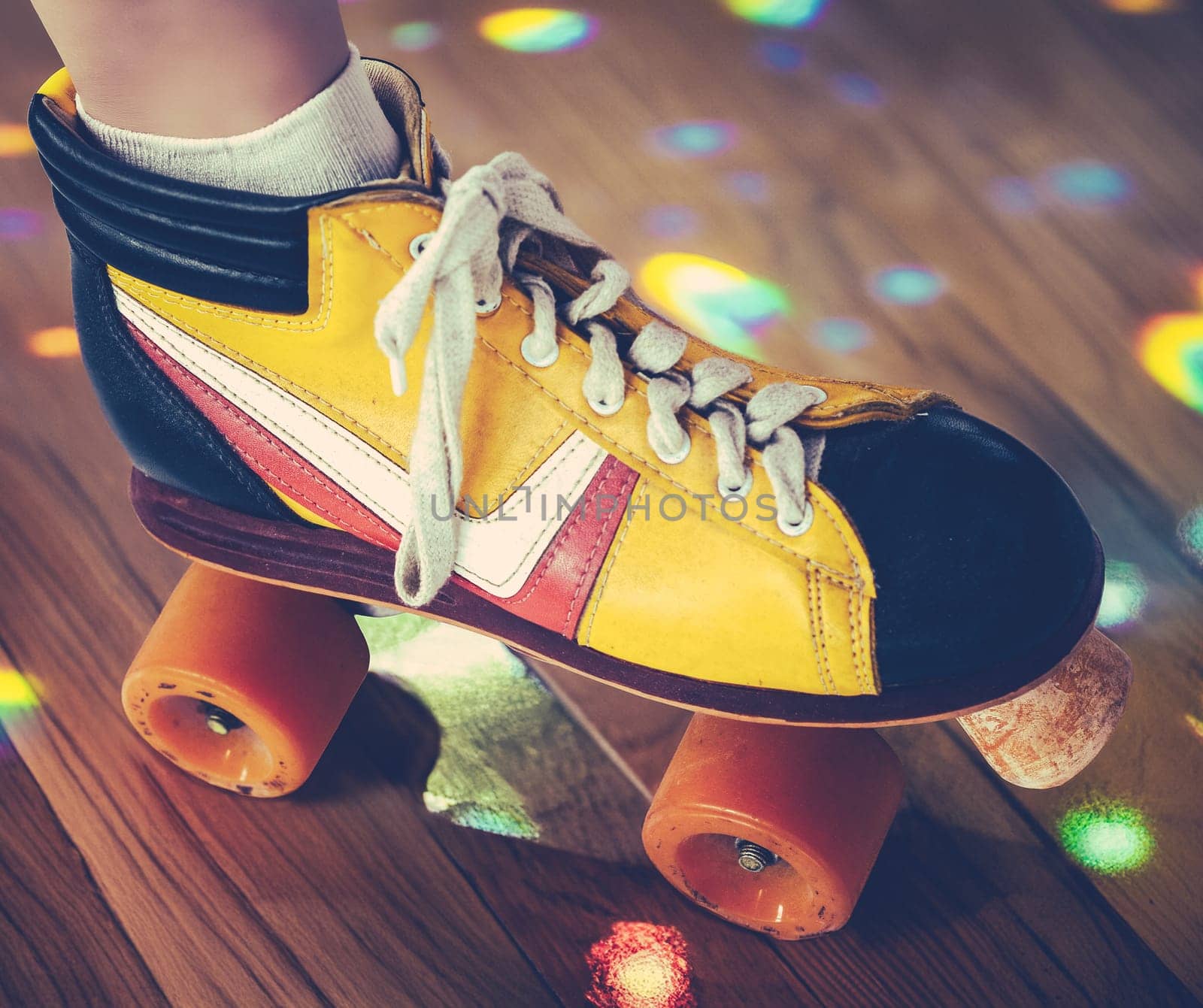 A Retro Vintage Quad Roller Skate At A Roller Disco With Reflected Lights On The Wooden Dance Floor