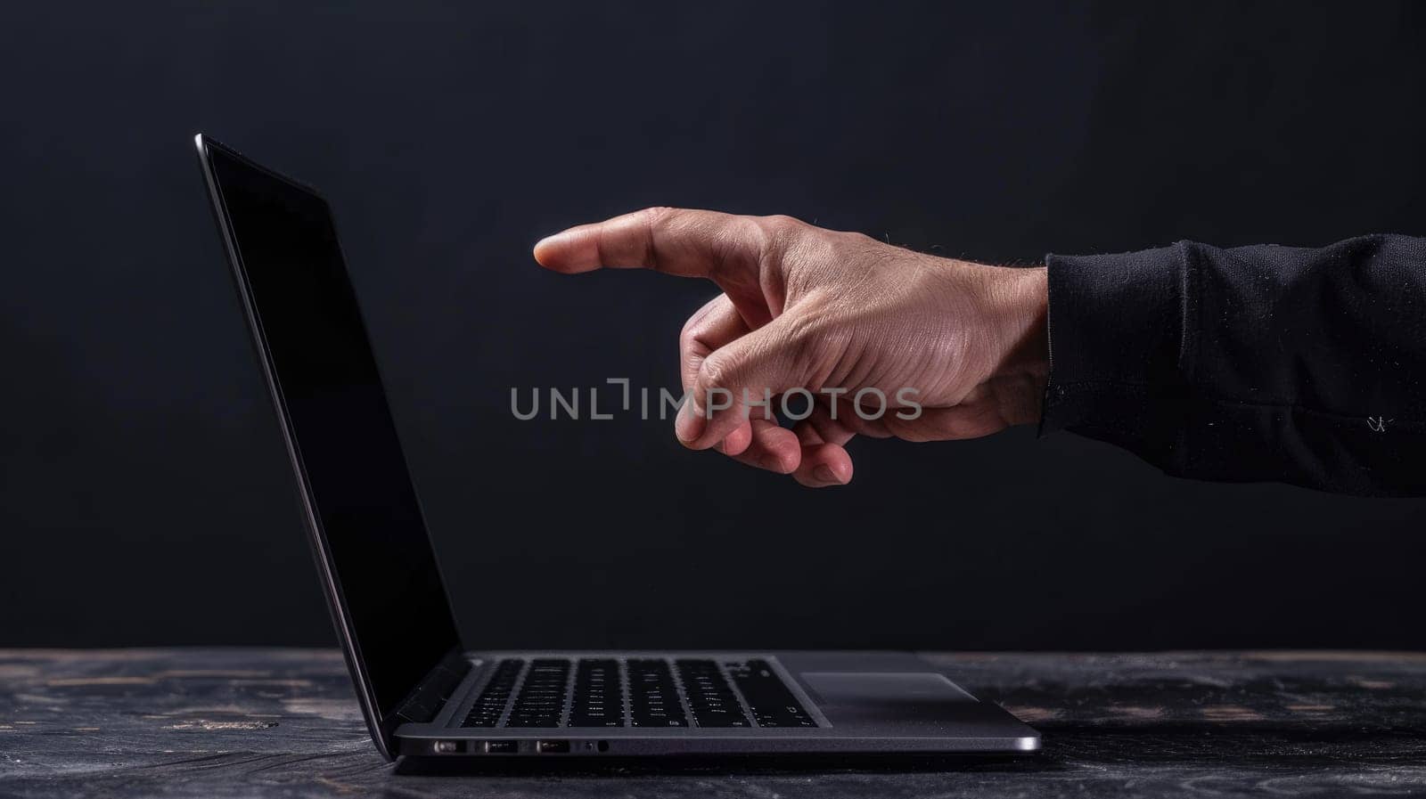 A hand reaching out to a laptop, Connection through technology.