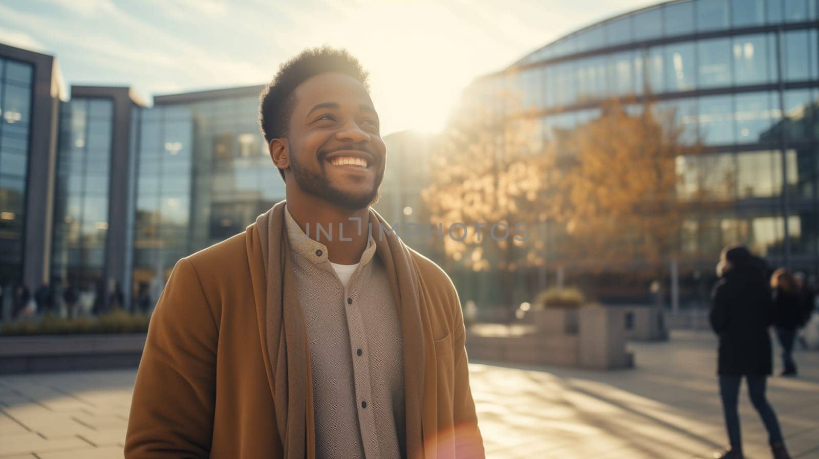 Fashionable portrait of stylish happy laughing black American young man standing in sunny city