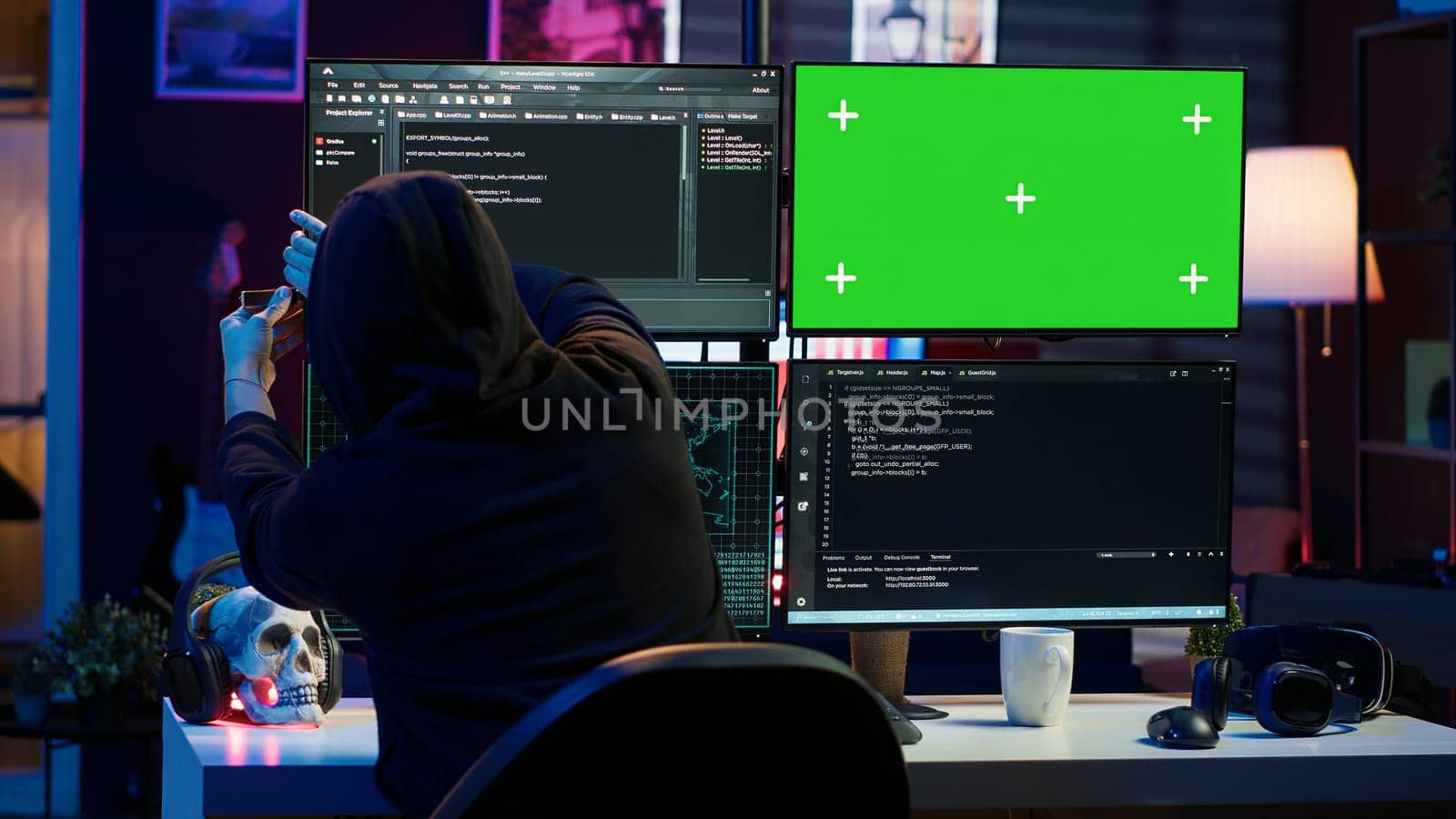 Cybercriminal uploading USB containing stolen information into green screen PC by DCStudio