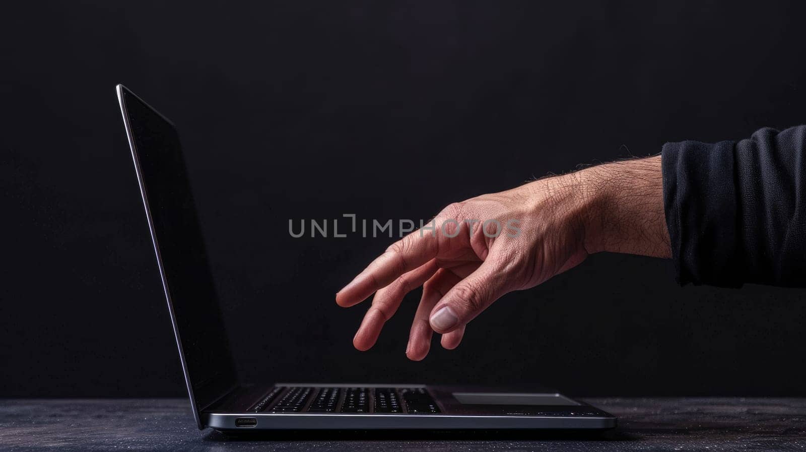 A hand reaching out to a laptop, Connection through technology.