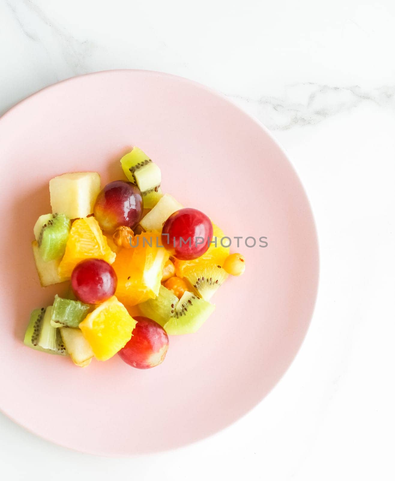 juicy fruit salad for breakfast on marble, flatlay - dieting and healthy lifestyle concept by Anneleven