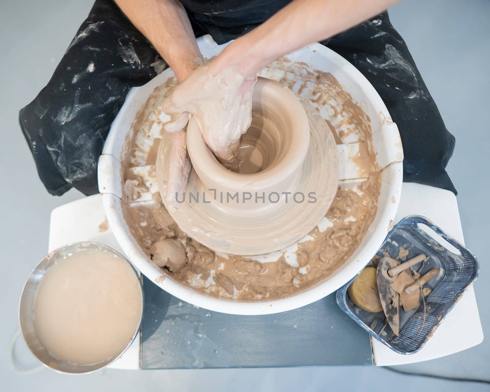 Close-up of a potter's hands working on a pottery wheel. by mrwed54