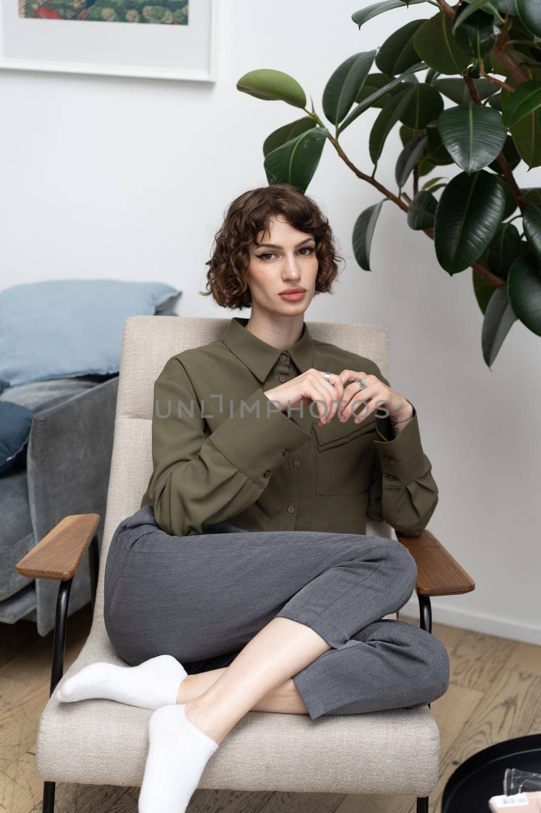 young beautiful woman posing in a green shirt in the studio