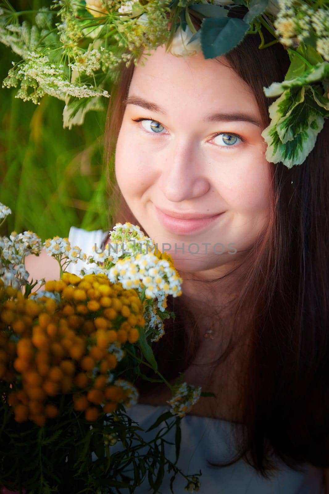 Portrait of Young plump Girl in White Sundress With Flower Wreath on nature at Sunset Celebrating Ivan Kupala Holiday