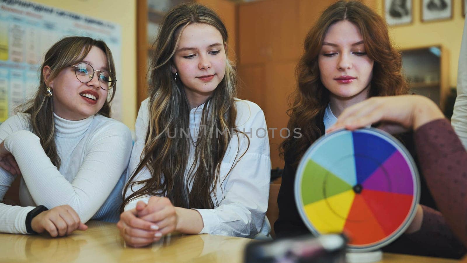 Students in physics class spin Newton's multicolored disk