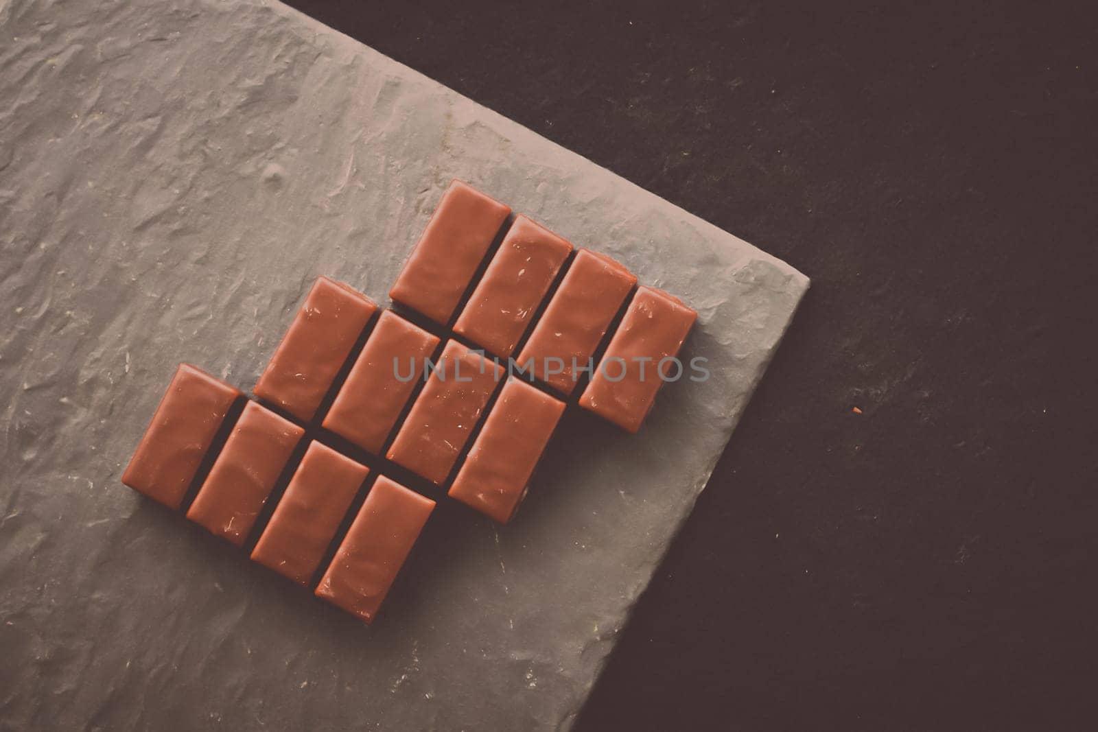 Sweet swiss chocolate candies on a stone tabletop, flatlay - desserts, confectionery and gluten-free organic food concept. All you need is chocolate