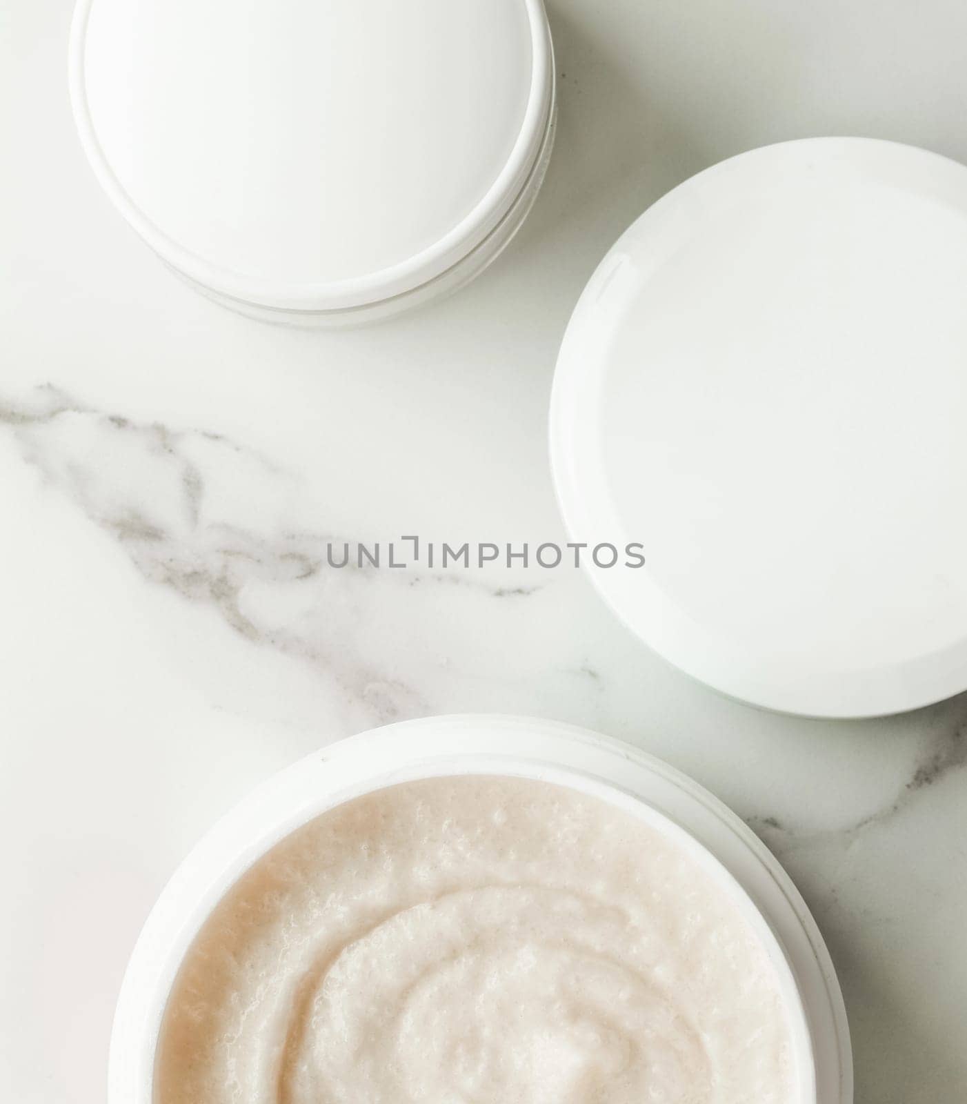 Scrub and exfoliating cream products on a marble, flatlay - skincare and body care, luxury spa and clean cosmetic concept. Health and beauty of your skin