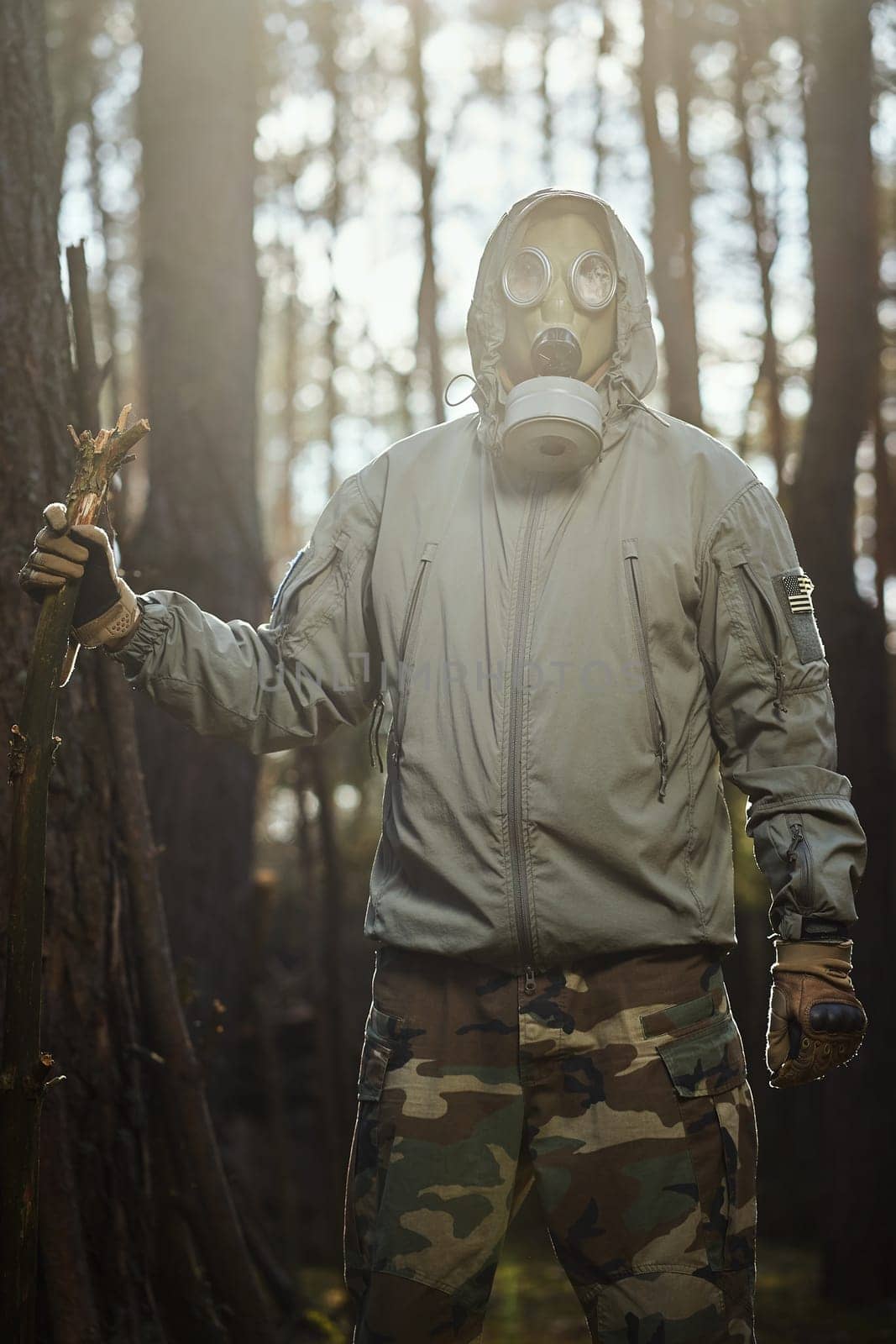 man in a gas mask protects himself from coronavirus in the woods