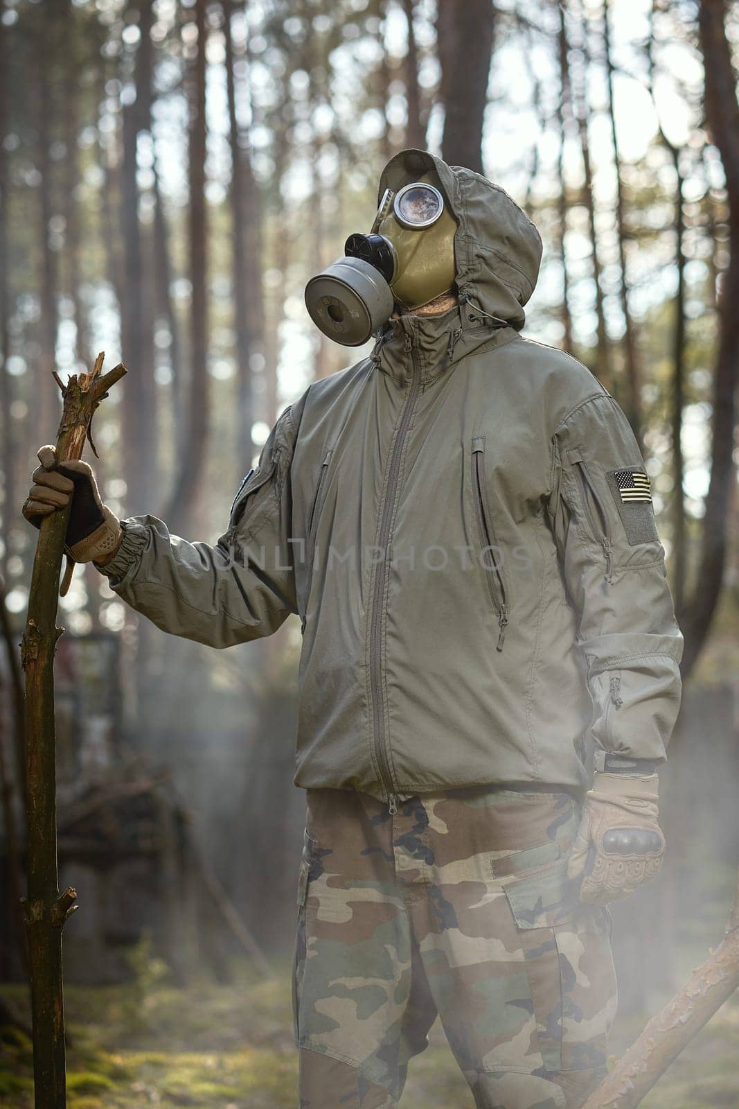 man in a gas mask protects himself from coronavirus in the woods