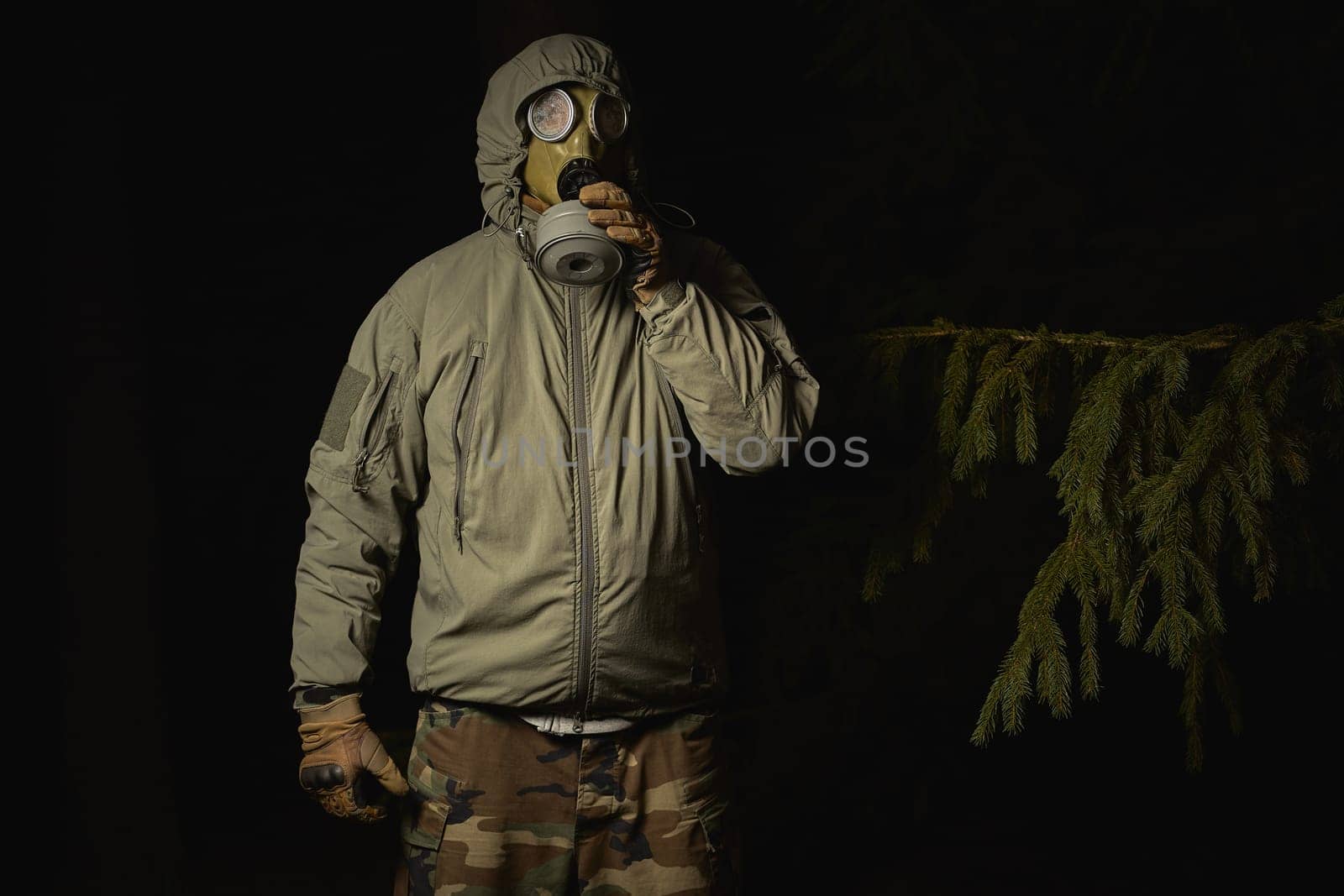 man in a gas mask protects himself from coronavirus at night