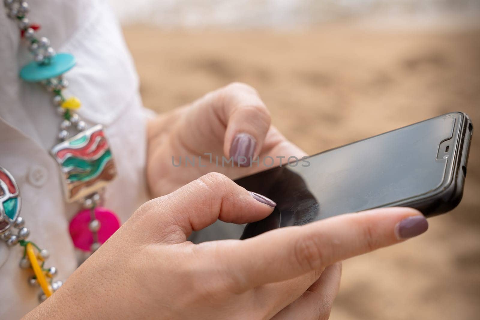 Woman hands typing on phone browsing telephone on social media.