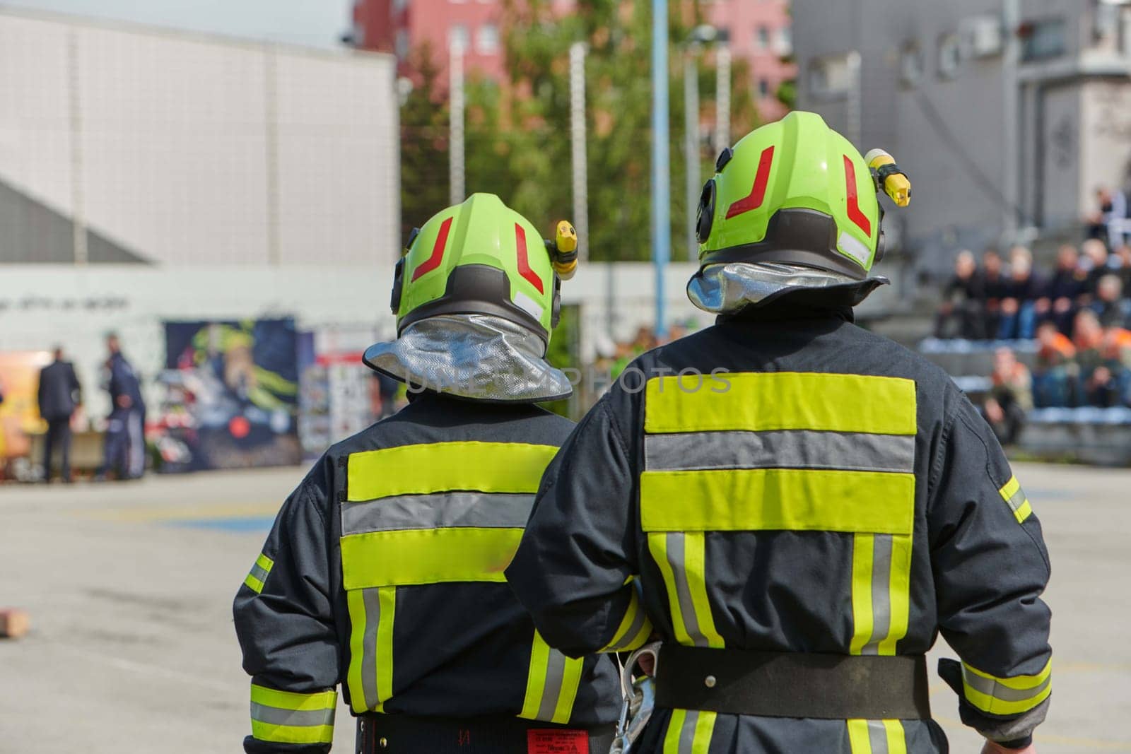 A team of confident and accomplished firefighters strides purposefully in their uniforms, exuding pride and satisfaction after successfully completing a challenging firefighting mission.