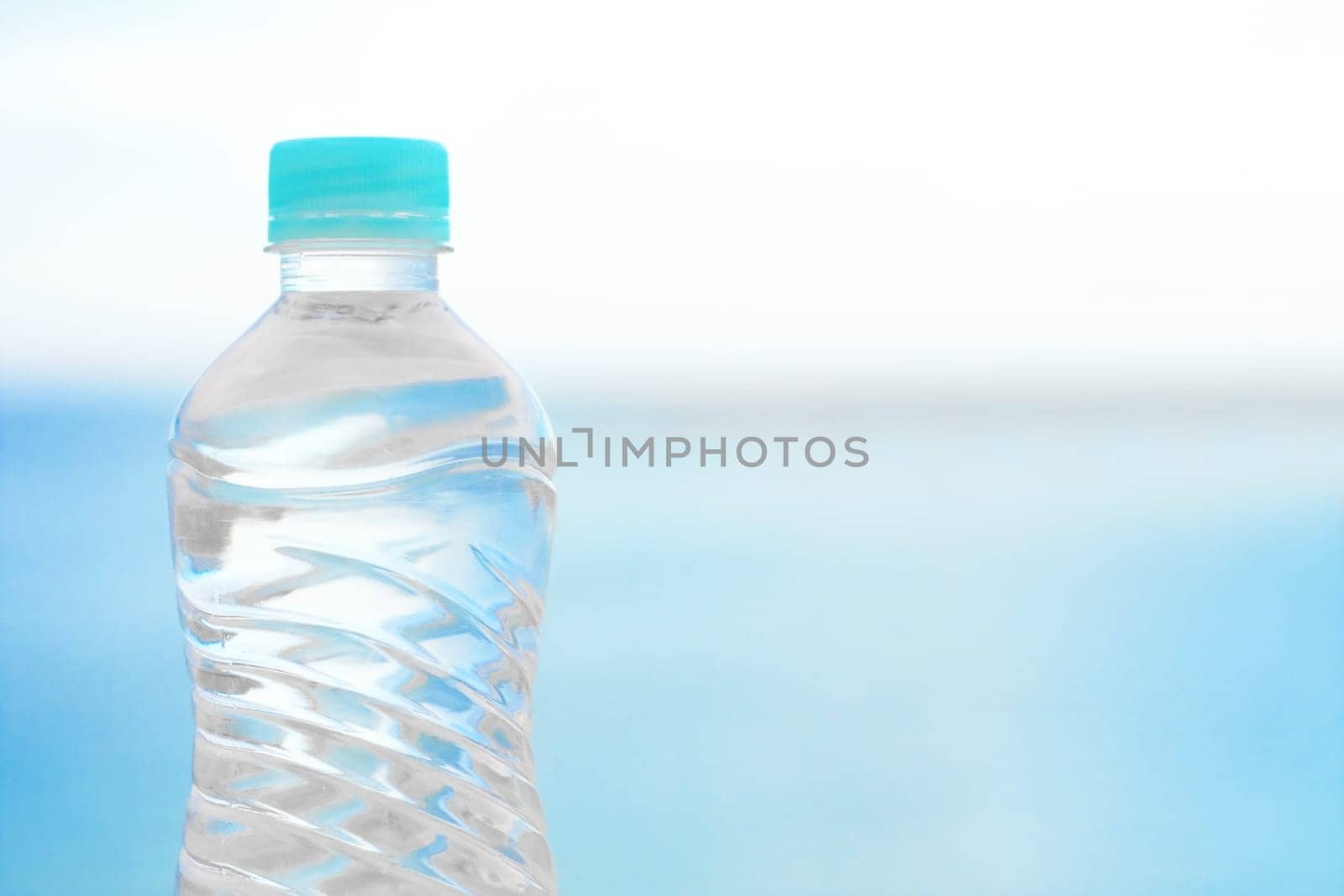 drinks, summertime and environment concept - bottle of water on the beach, elegant visuals