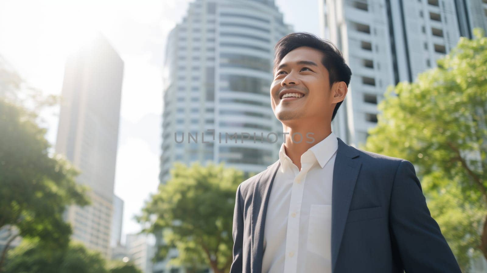 Confident happy smiling Asian businessman standing in the city, young man entrepreneur in business suit, looking away