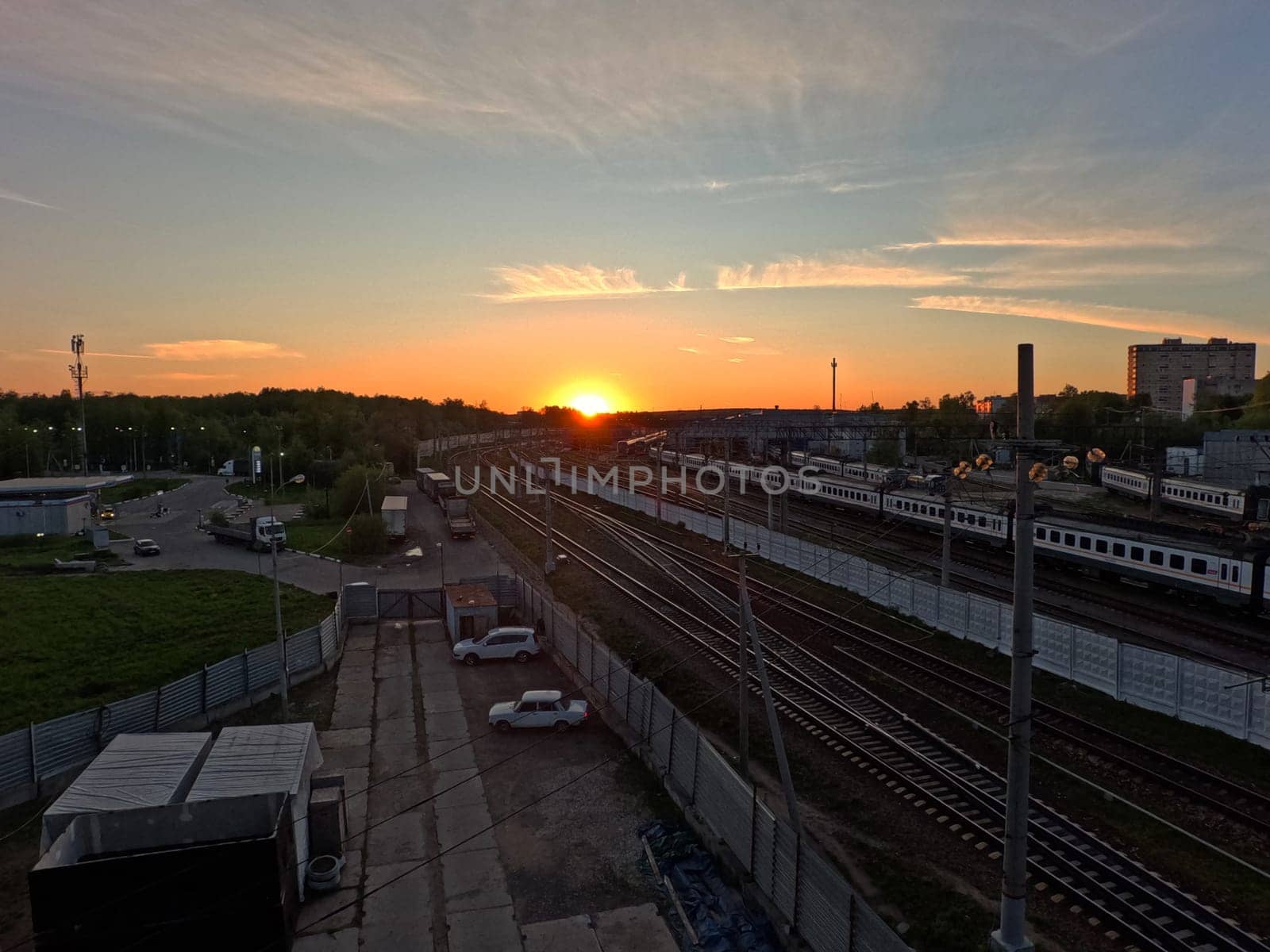 Sunset against the background of railway infrastructure solutions. sunset over the depot. High quality photo