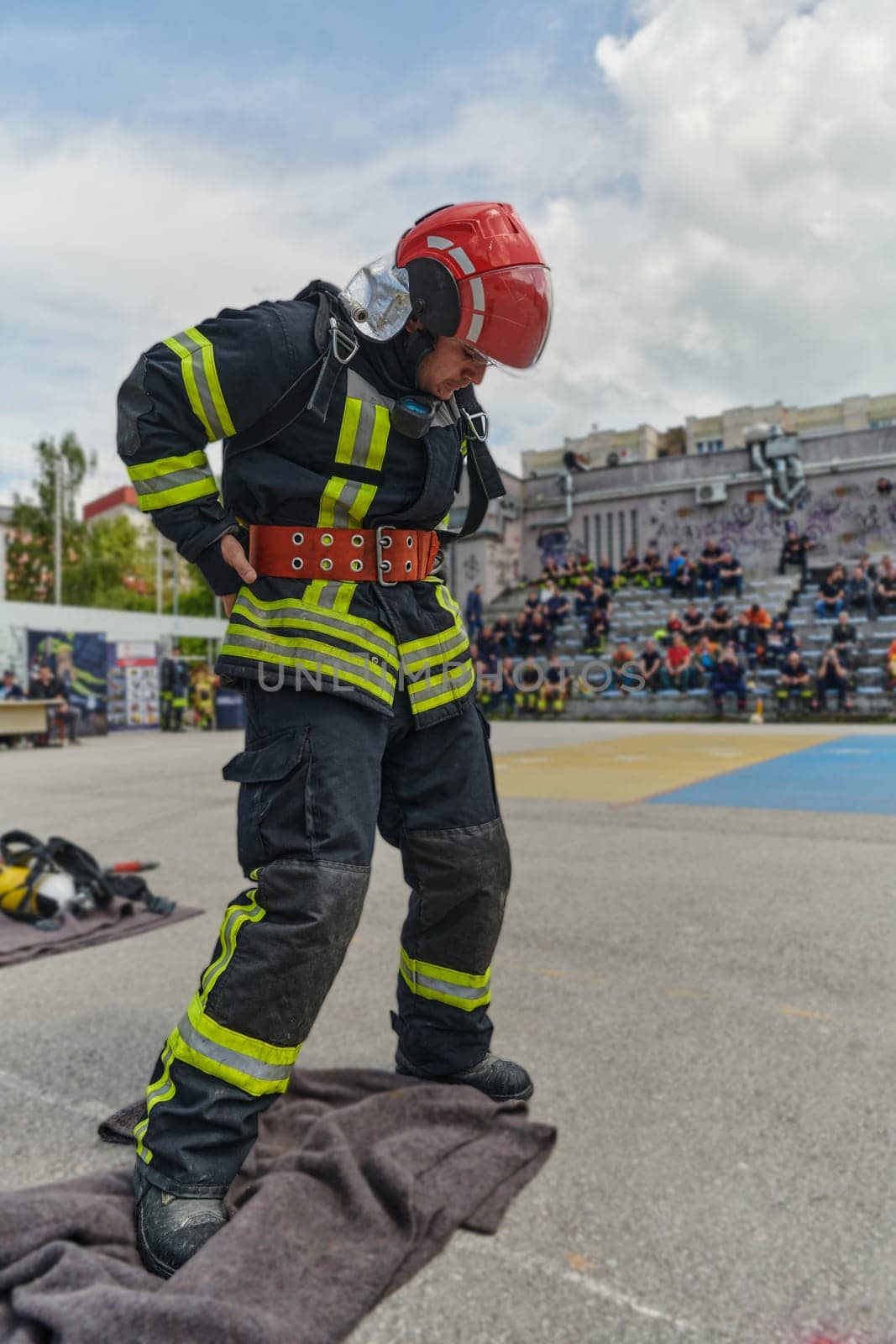 A firefighter dons the essential components of their professional gear, embodying resilience, commitment, and readiness as they gear up for a hazardous firefighting mission, a testament to their unwavering dedication to protecting and saving lives by dotshock