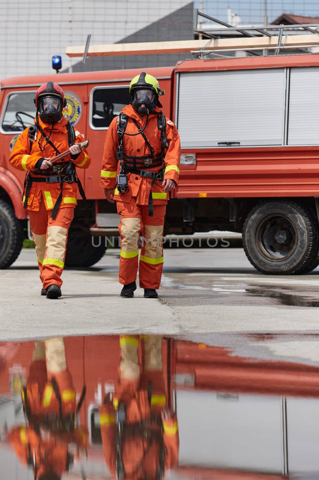 A team of confident and accomplished firefighters strides purposefully in their uniforms, exuding pride and satisfaction after successfully completing a challenging firefighting mission.