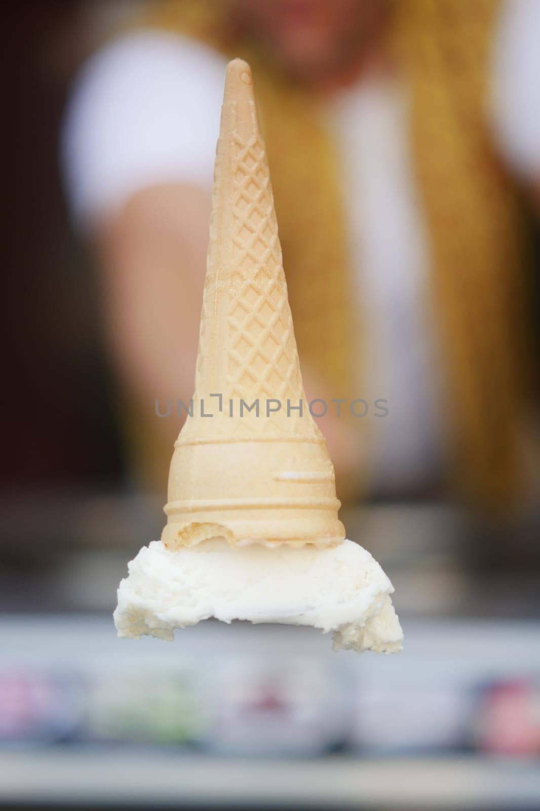 Ice cream cone balanced upside down on a scoop of vanilla a cool and unique ice cream trick for some fun