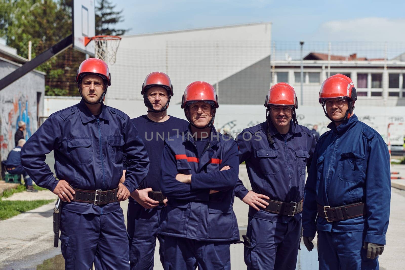 A team of confident and accomplished firefighters strides purposefully in their uniforms, exuding pride and satisfaction after successfully completing a challenging firefighting mission.