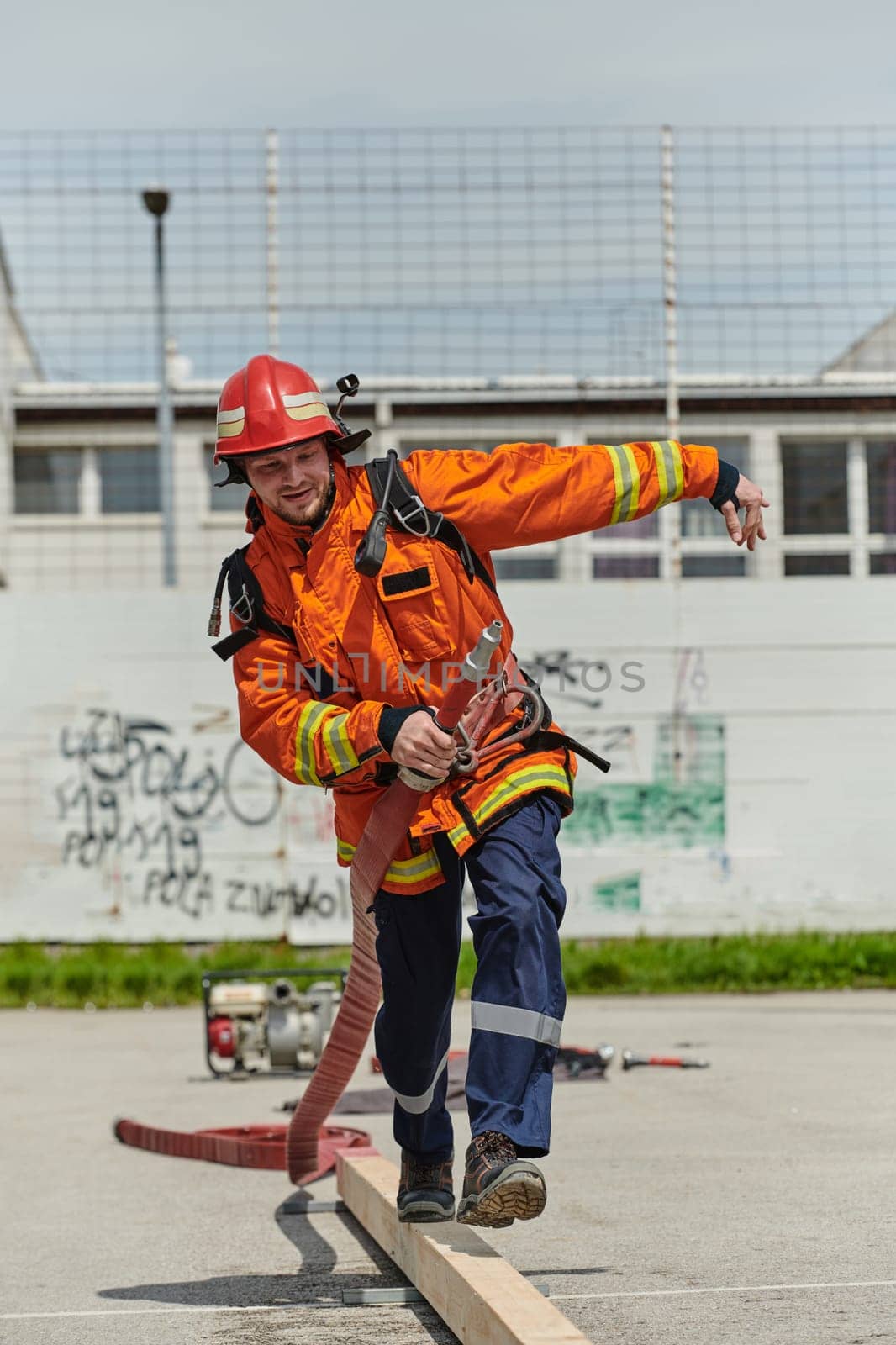 A firefighter, clad in professional gear, undergoes rigorous training to prepare for the hazards awaiting him on duty