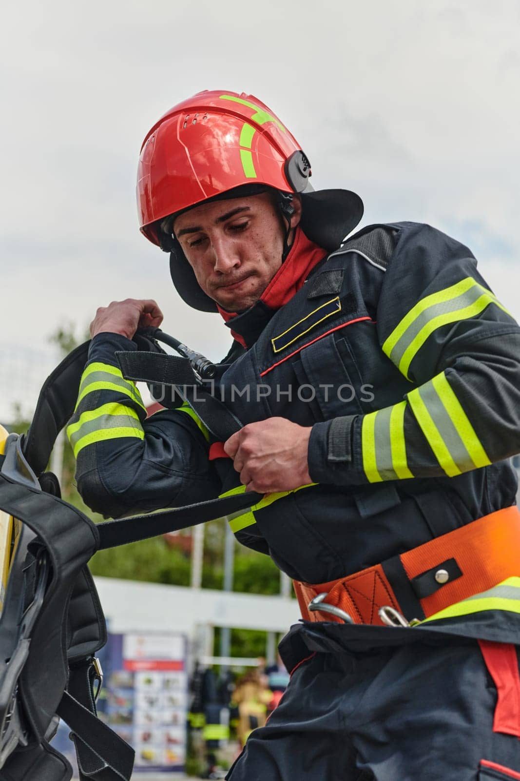 Professional Firefighter Suits Up in Full Gear for Duty by dotshock