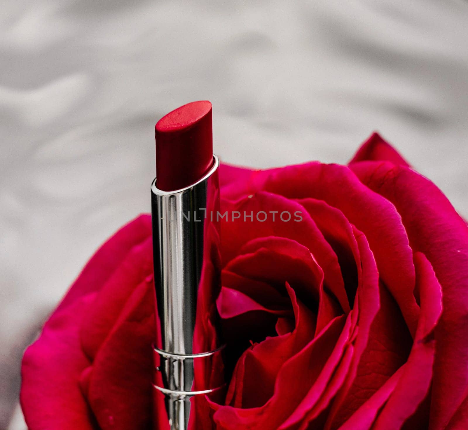 luxe red lipstick and a wonderful rose - make-up and cosmetics styled beauty concept by Anneleven