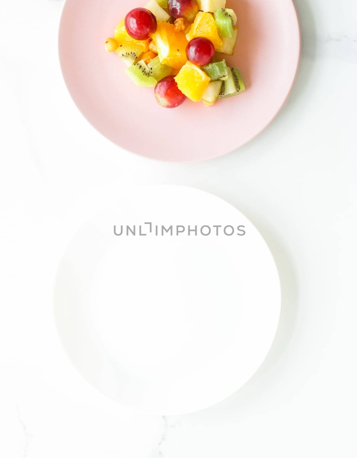 juicy fruit salad for breakfast on marble, flatlay - dieting and healthy lifestyle concept by Anneleven