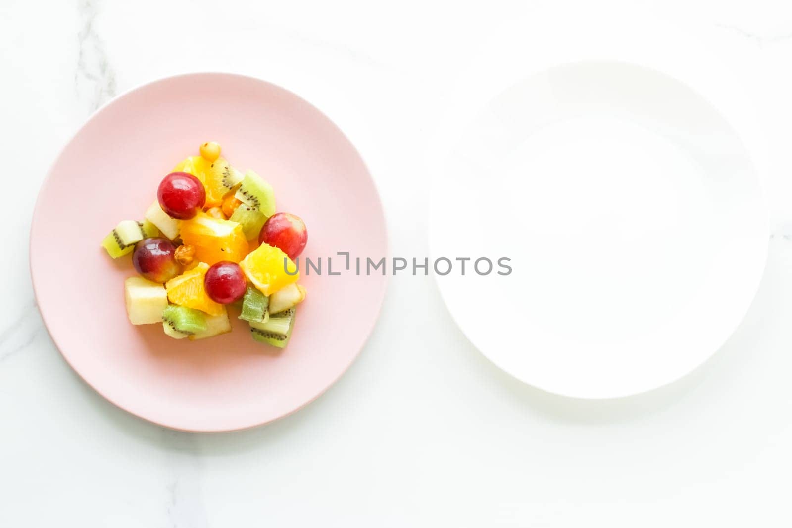 juicy fruit salad for breakfast on marble, flatlay - dieting and healthy lifestyle concept by Anneleven