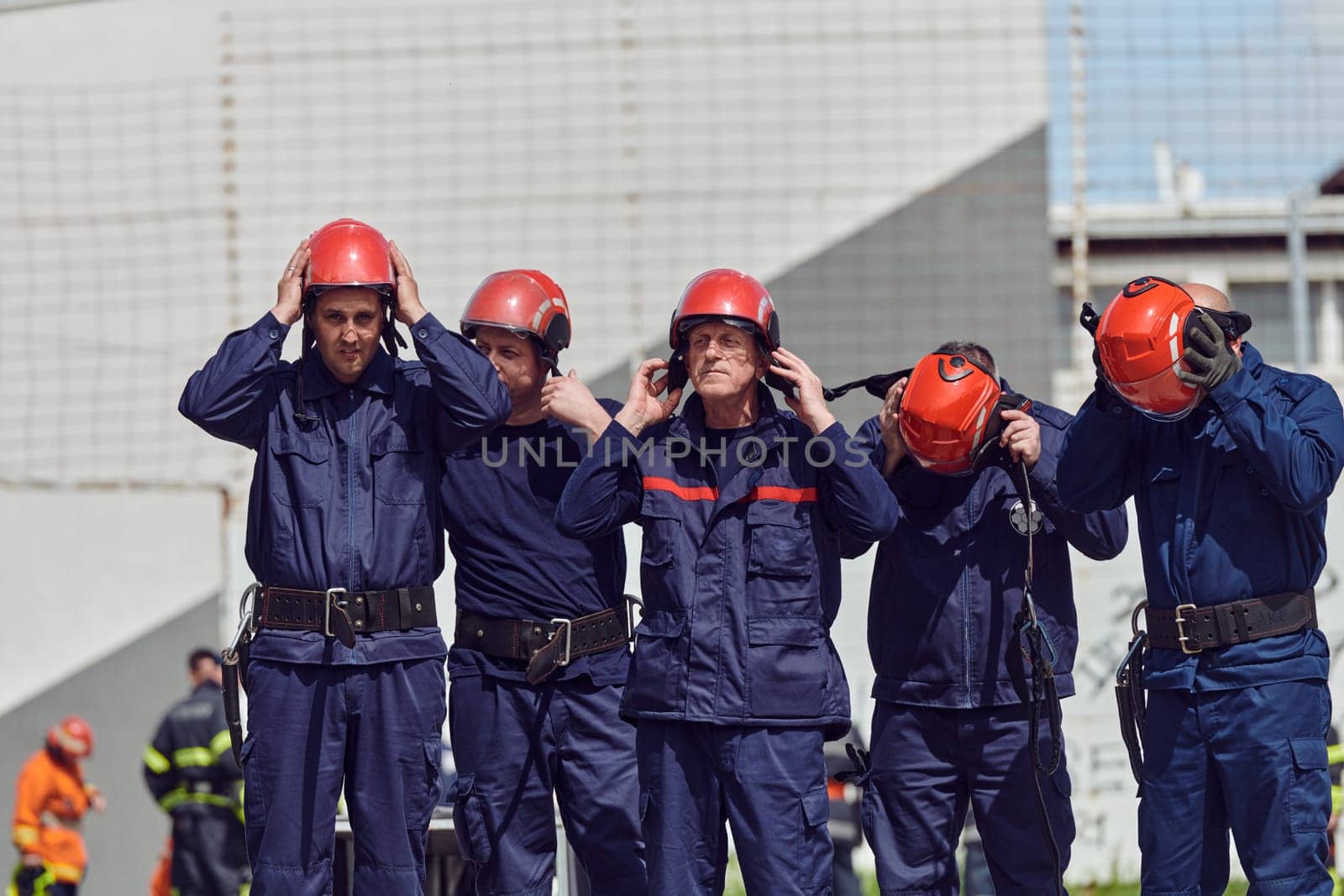 A team of confident and accomplished firefighters strides purposefully in their uniforms, exuding pride and satisfaction after successfully completing a challenging firefighting mission.