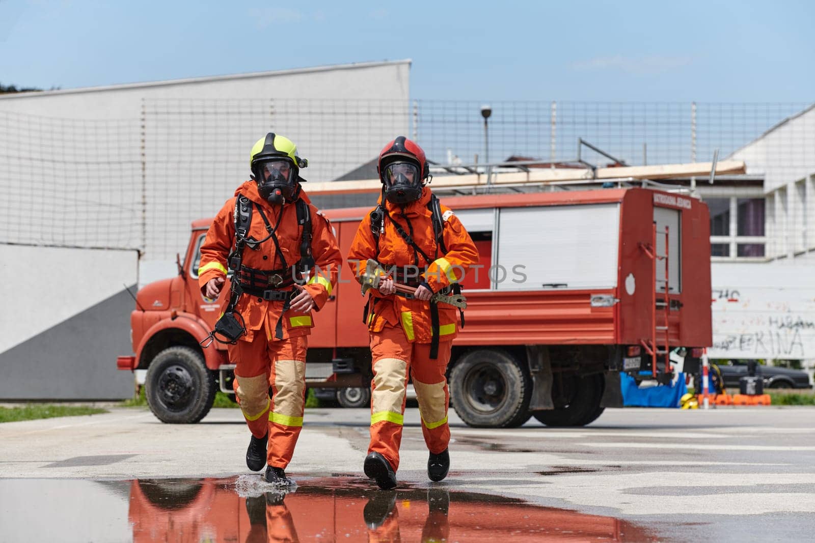 A team of confident and accomplished firefighters strides purposefully in their uniforms, exuding pride and satisfaction after successfully completing a challenging firefighting mission.