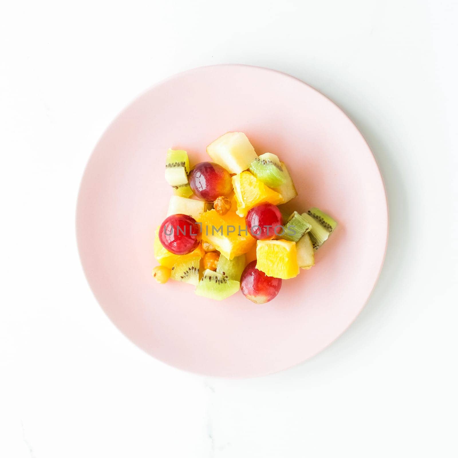 juicy fruit salad for breakfast on marble, flatlay - dieting and healthy lifestyle styled concept