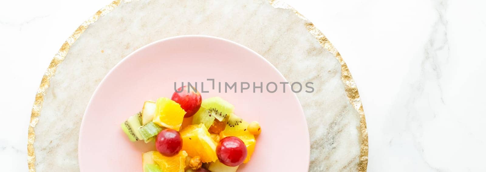 juicy fruit salad for breakfast on marble, flatlay - dieting and healthy lifestyle styled concept