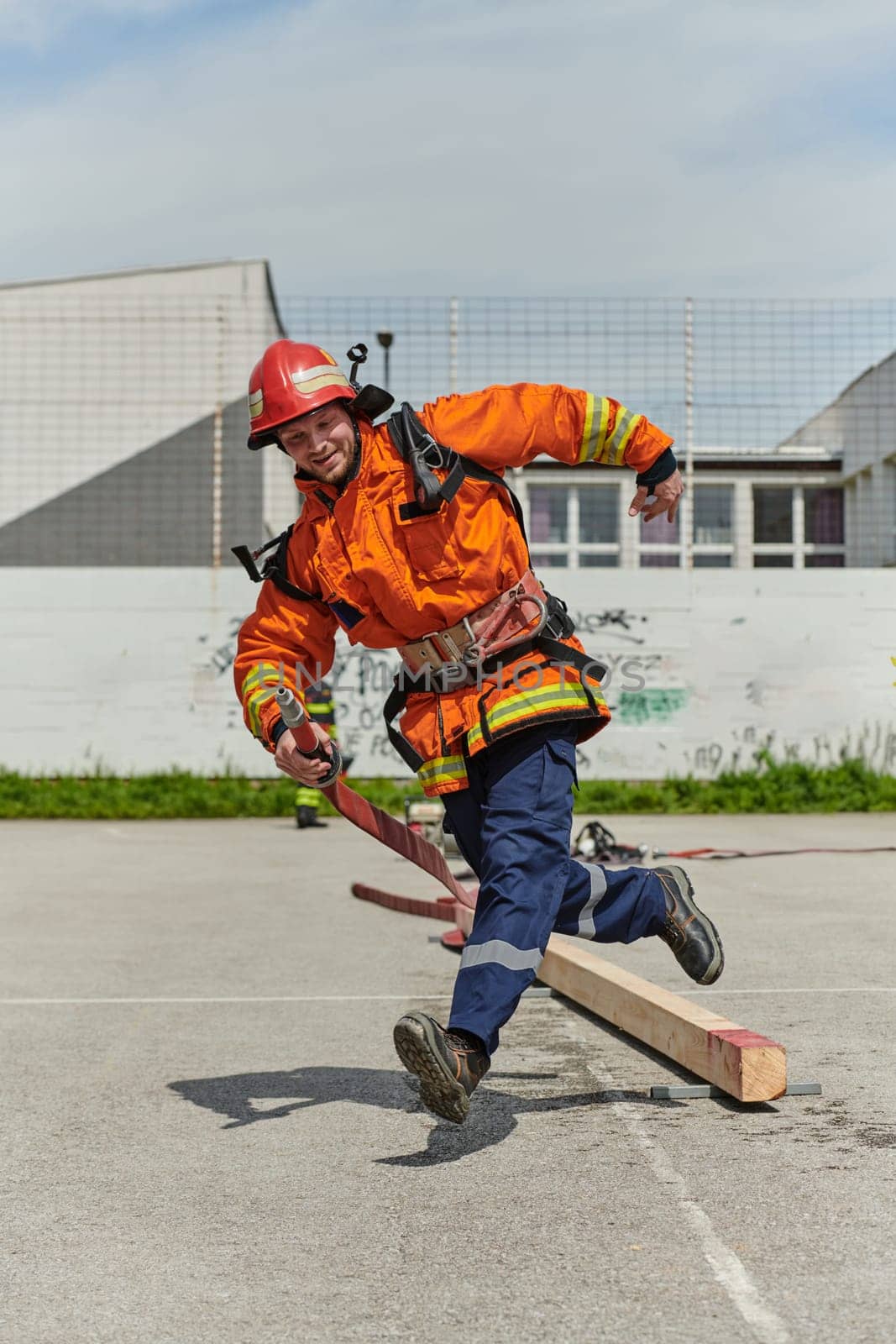 A firefighter, clad in professional gear, undergoes rigorous training to prepare for the hazards awaiting him on duty