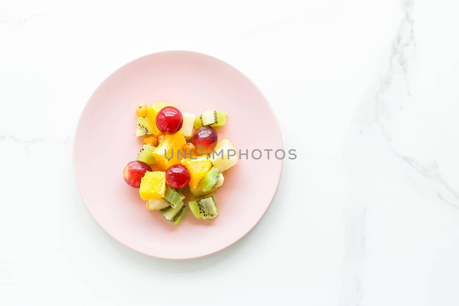 juicy fruit salad for breakfast on marble, flatlay - dieting and healthy lifestyle styled concept