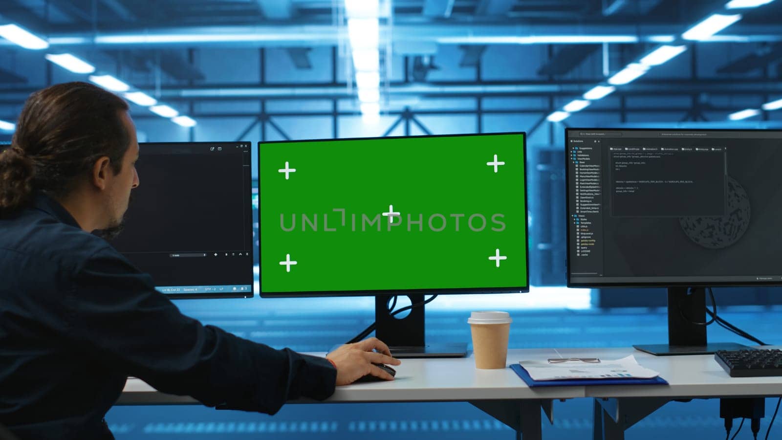 Software developer using green screen PC to do programming in server room providing computing resources for workloads. IT expert supervising data center supercomputers using mockup computer monitor